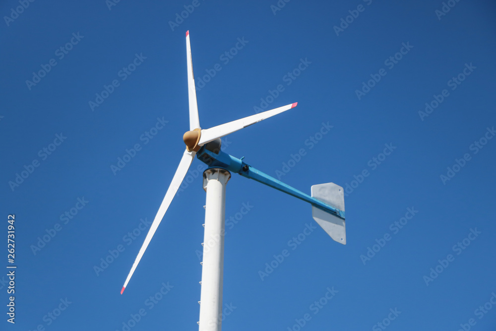 Wind turbines generate electricity. clean energy with cloud background on the blue sky. Wind turbines generate electricity. clean energy with cloud background on the blue sky.
