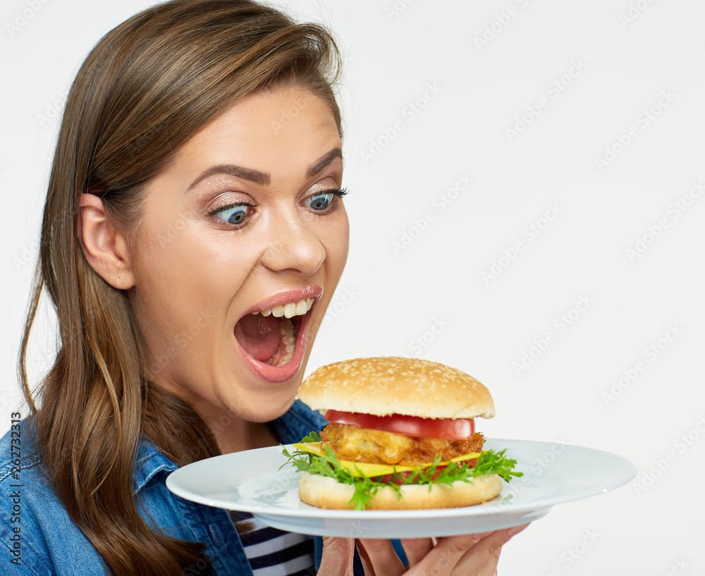 woman eating big burger. Isolated portrait.