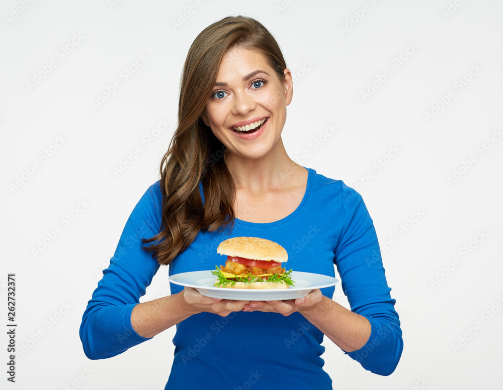 smiling woman holding plate with hamburger. smiling woman holding plate with hamburger.