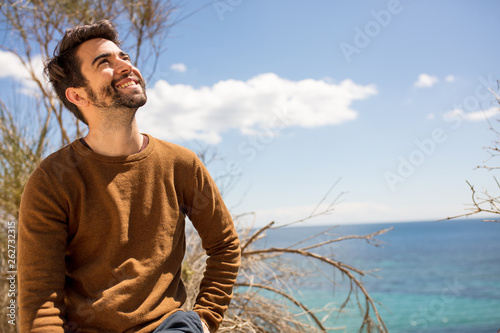 young man happy and looking up