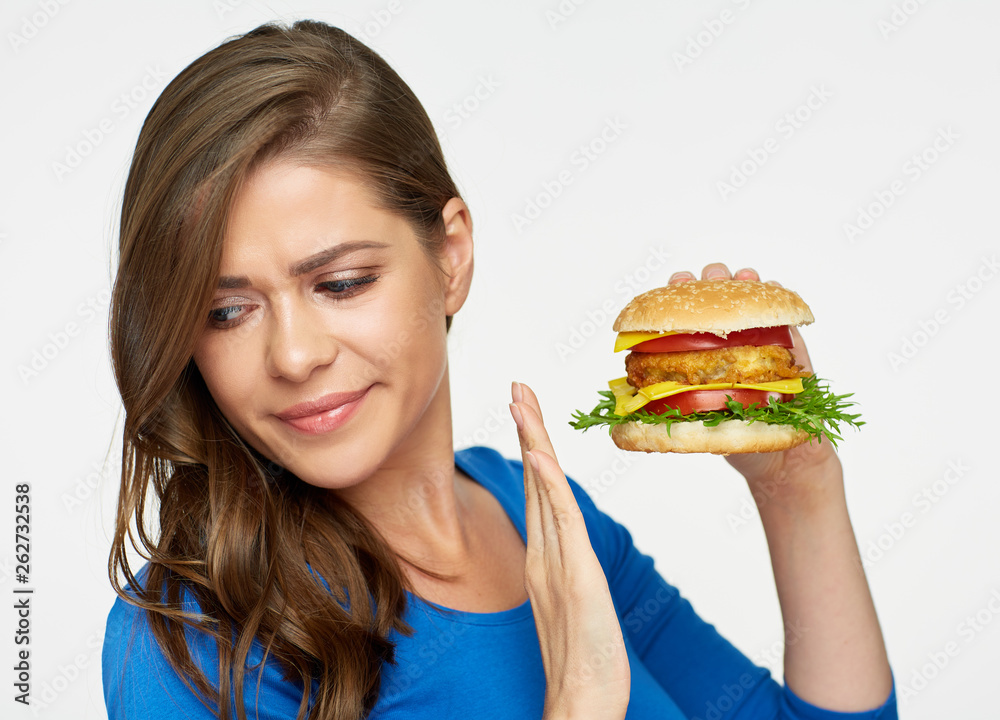 concept with dieting woman refusing fast food meal, hamburger. concept with dieting woman refusing fast food meal, hamburger.