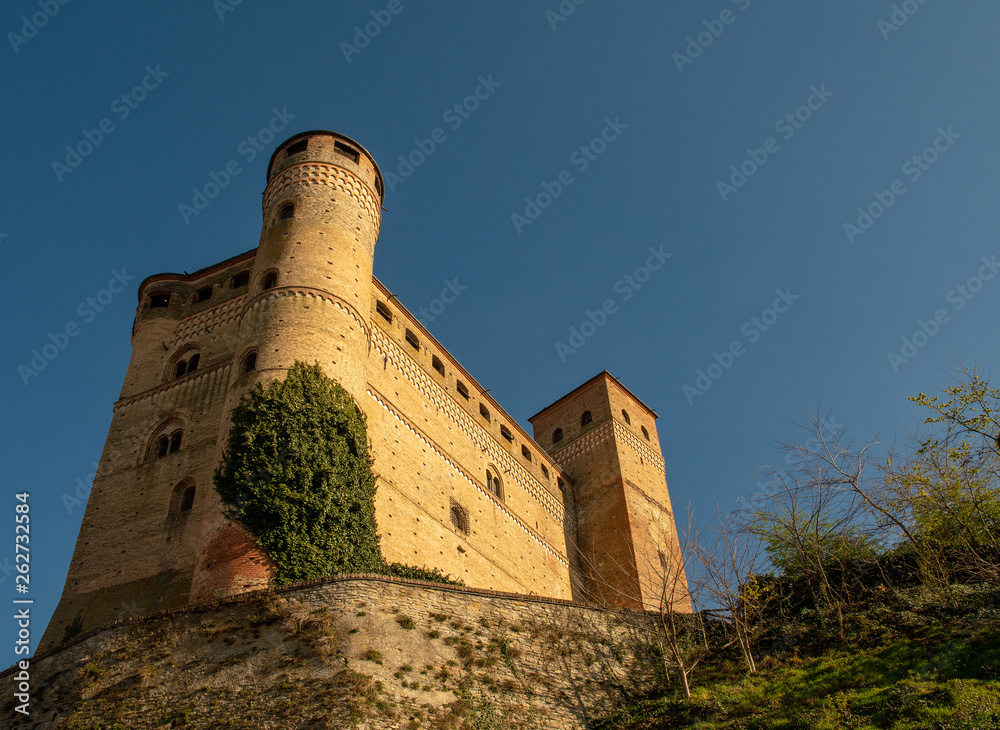 Low angle view of the medieval Castle of Serralunga d'Alba (1340-1357), considered to be one of the best-conserved examples of 14th century noble castles in Piedmont, Langhe region, Italy Low angle view of the medieval Castle of Serralunga d'Alba (1340-1357), considered to be one of the best-conserved examples of 14th century noble castles in Piedmont, Langhe region, Italy