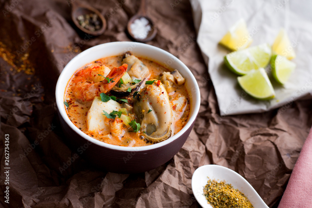 Soup with king prawns, seafoods, mussels. Lime and garlic. Spices and pepper. Top view. Diet. Dinner. Homemade Soup with king prawns, seafoods, mussels. Lime and garlic. Spices and pepper. Top view. Diet. Dinner. Homemade