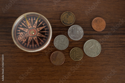 Compass and coins. Table traveler.