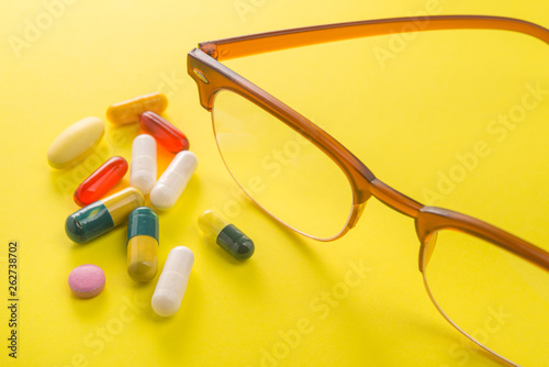 Old style glasses with vitamin and pills
