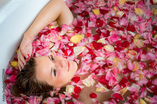 girl in the bathroom with rose petals, close up portrait