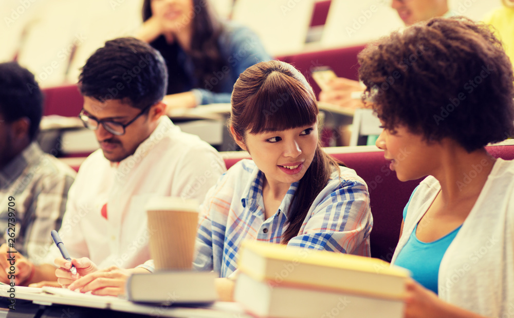 education, high school, university, learning and people concept - group of international students talking on lecture education, high school, university, learning and people concept - group of international students talking on lecture
