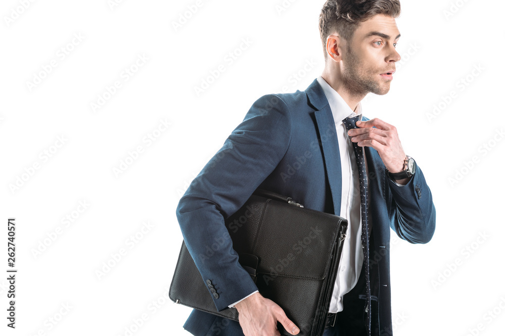 good-looking businessman holding briefcase and touching tie isolated on white good-looking businessman holding briefcase and touching tie isolated on white