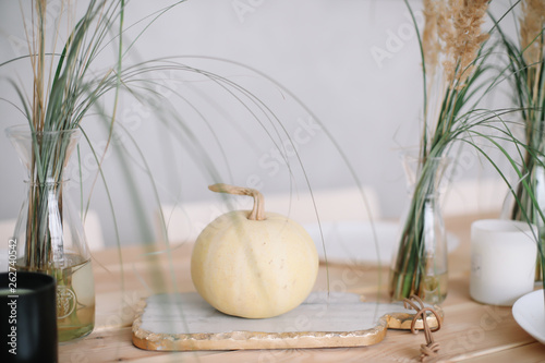 Holiday table decoration with white decorative pumpkinon wooden background. Autumn composition. Autumn, fall, Halloween, Thanksgiving day concept. Flat lay, top view photo