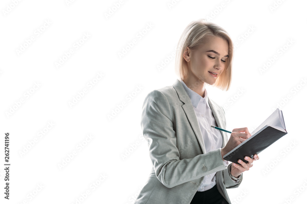 cheerful, attractive businesswoman with blonde hair writing in notebook isolated on white cheerful, attractive businesswoman with blonde hair writing in notebook isolated on white