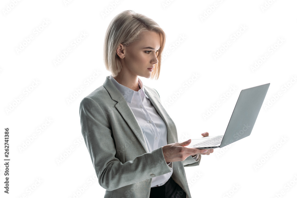 pretty, blond, attentive businesswoman holding laptop isolated on white pretty, blond, attentive businesswoman holding laptop isolated on white