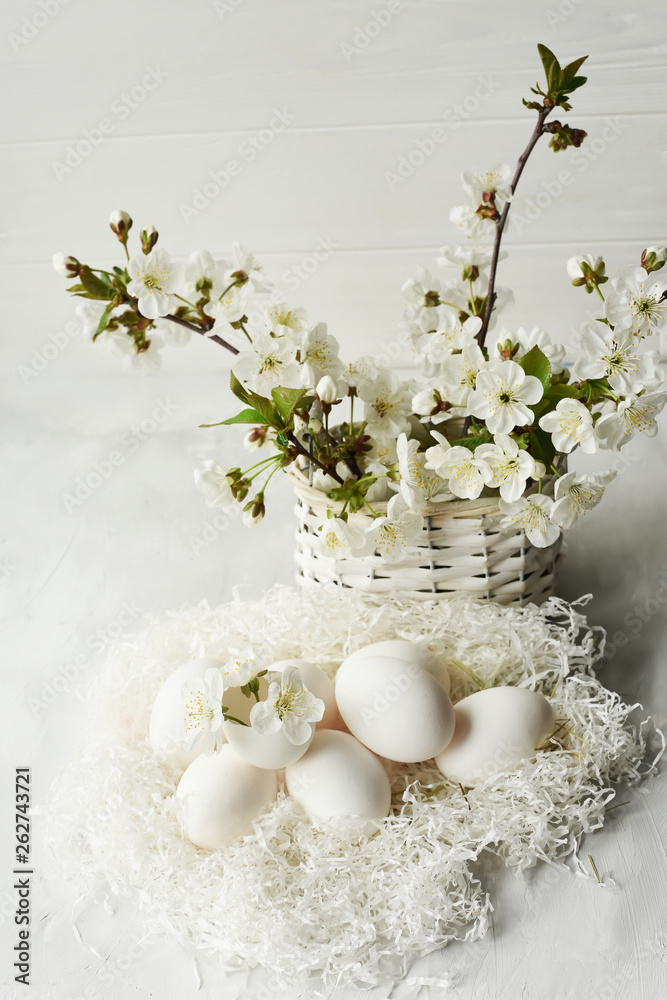 Easter still life. Gentle bright photo of egg and cherry blossoms.