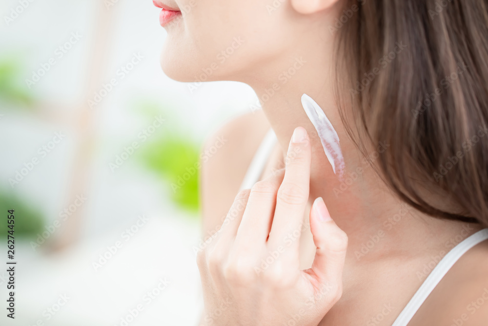 woman applying cream on neck woman applying cream on neck