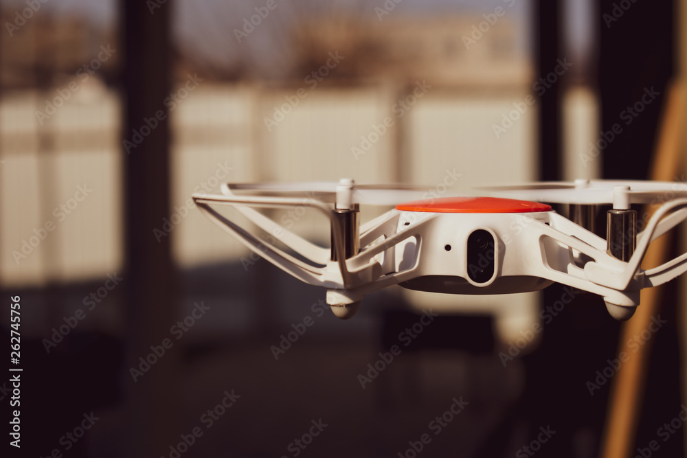 Quadcopter drone in flight with digital camera. Quadcopter drone in flight with digital camera.