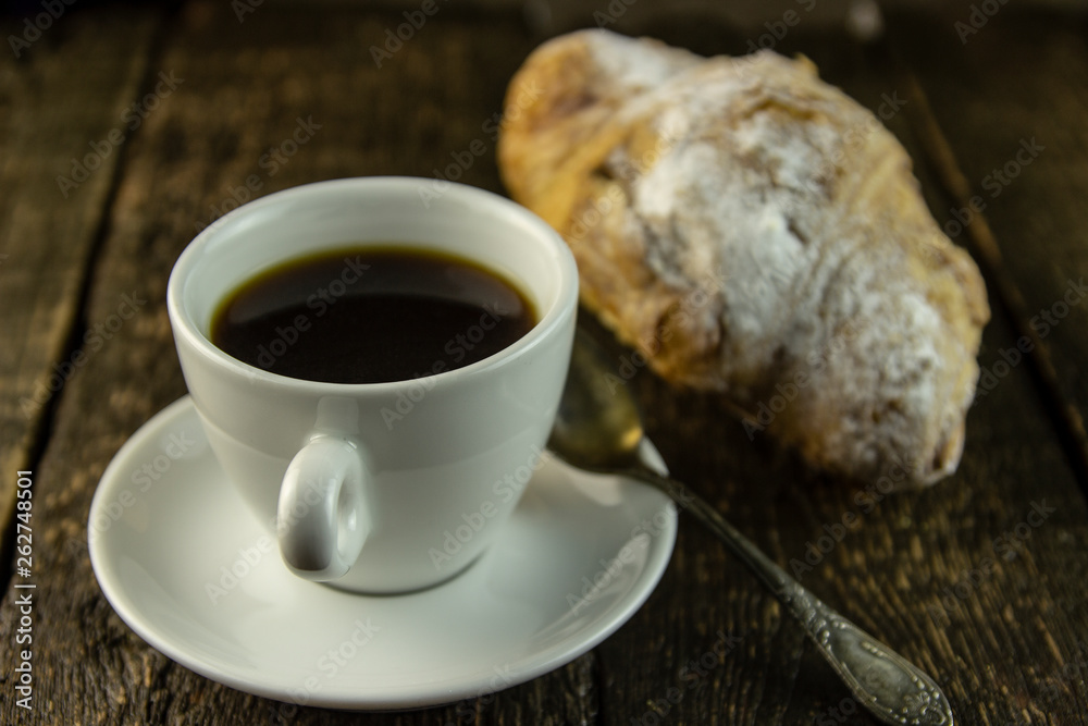 Cup of coffee and sweet buns on a rough wooden background Cup of coffee and sweet buns on a rough wooden background