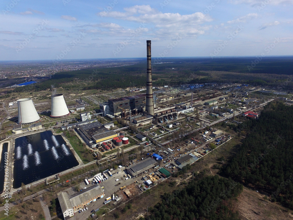 Chimney of power plant in the forest. Drone aerial view.  Near Kiev,Ukraine