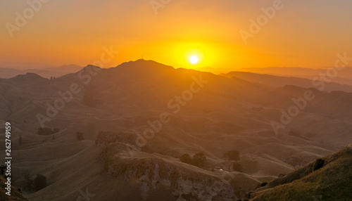 Sunset in the mountain near Waikaremoana New Zealand East Coast. Beautiful sunset view from the mountains. Sun hides behind the mountains.