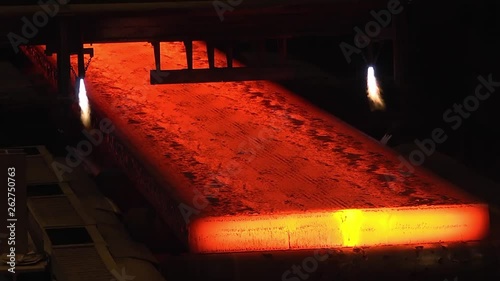 Steel mill, steel sheet production, transportation of hot sheets on the production line, heavy industry, metal rolling plant. Conveyor line metal rolling mill. Machine continuous casting blanks.