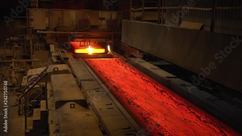 Steel mill, steel sheet production, transportation of hot sheets on the production line, heavy industry, metal rolling plant. Conveyor line metal rolling mill. Machine continuous casting blanks.