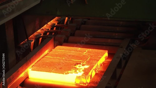 Steel plant, production of steel sheets, transportation of hot sheets on the production line, heavy industry, metal rolling plant. Conveyor line metal rolling mill. Close up.