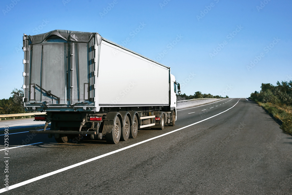 The truck is going up the road. Cargo transportation concept. The truck is going up the road. Cargo transportation concept.
