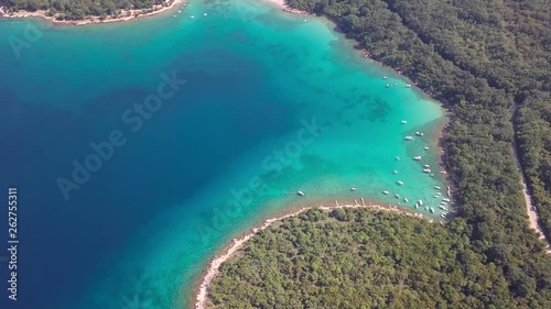 Aerial view of crystal clear water off the coastline inisland with boats Krk, Croatia photo