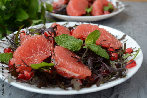  Diet salad with grapefruit, herbs and pomegranate. Gourmet food.