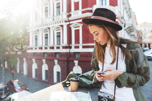 Pretty young girl tourist analyzing city map