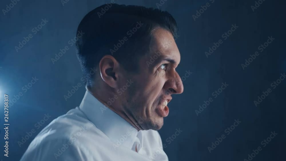 Portrait of Businessman screams on black background, anger emotions Portrait of Businessman screams on black background, anger emotions