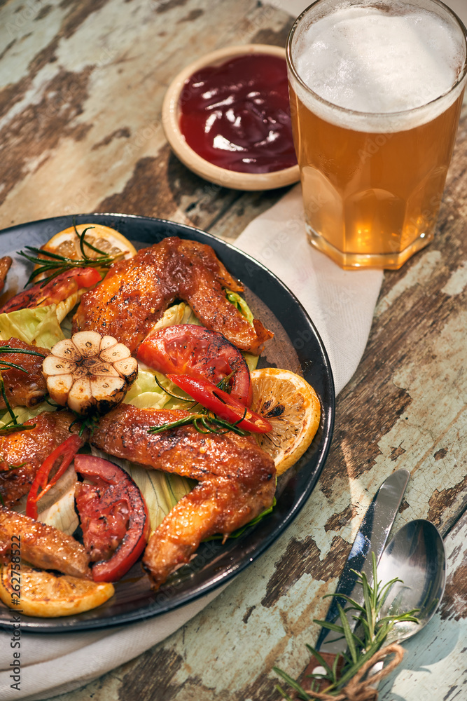 Grilled chicken wings spiced with chili peppers and rosemary Grilled chicken wings spiced with chili peppers and rosemary