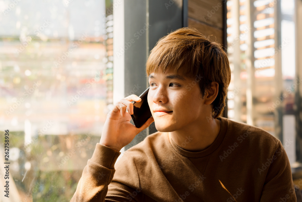 Confident creative manager of media marketing agency having phone conversation with executive manager discussing details of new startup project while sitting in coffee shop with free wifi zone Confident creative manager of media marketing agency having phone conversation with executive manager discussing details of new startup project while sitting in coffee shop with free wifi zone