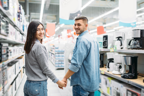 Couple in department of household appliances, shop
