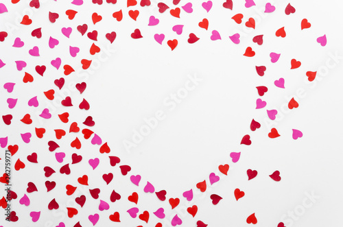 Top view heart shaped border arrangement with small hearts with copy space for 8 march or valentine day greeting card