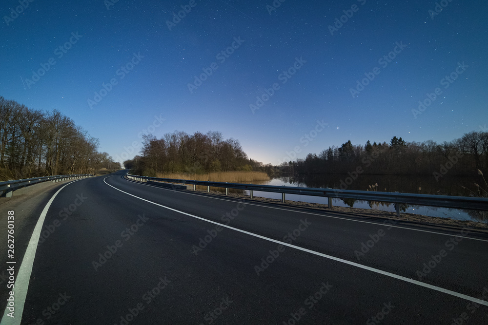 Turn of a highway at bright Moonlight night Turn of a highway at bright Moonlight night