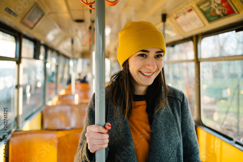 Photography Young woman standing in a wagon of a driving tramway
