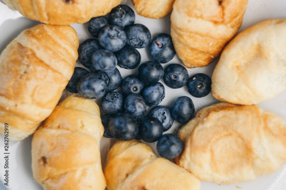 healthy light breakfast. blueberries, croissants on a plate. close up, top view. proper nutrition for a slim figure. raw food vegetarianism. diet