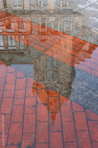 Reflection of the building on puddle