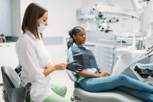 Female patient on chair and dentist, dental clinic