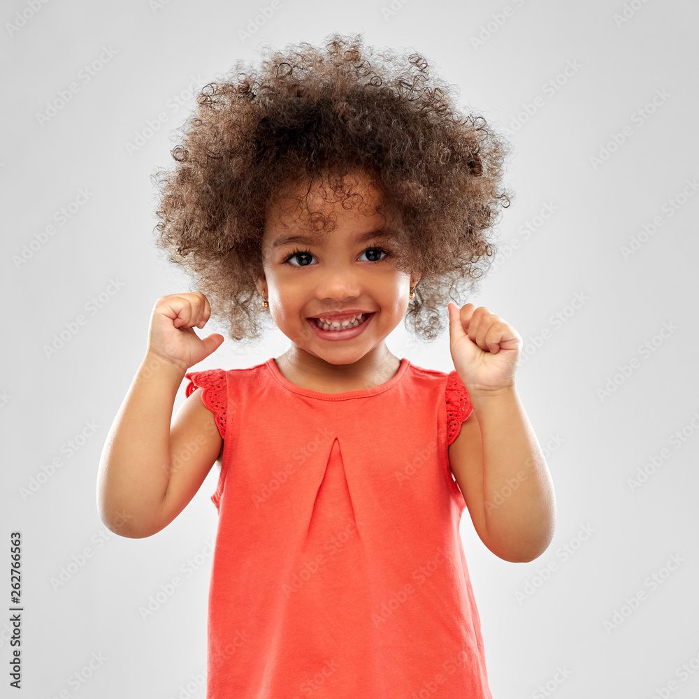 childhood and people concept - happy little african american girl over grey background - obrazy, fototapety, plakaty 