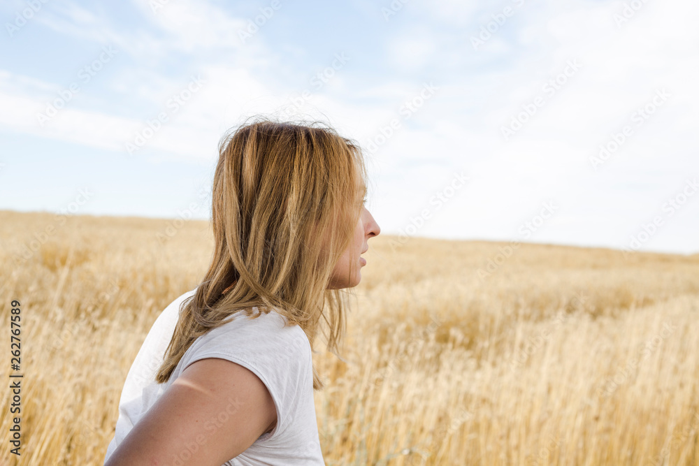 Portrait of beautiful young woman in stylish clothes posing on field Portrait of beautiful young woman in stylish clothes posing on field