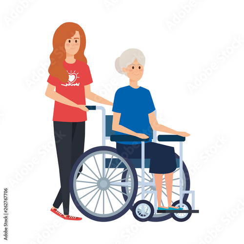 young woman volunteer with old woman in wheelchair