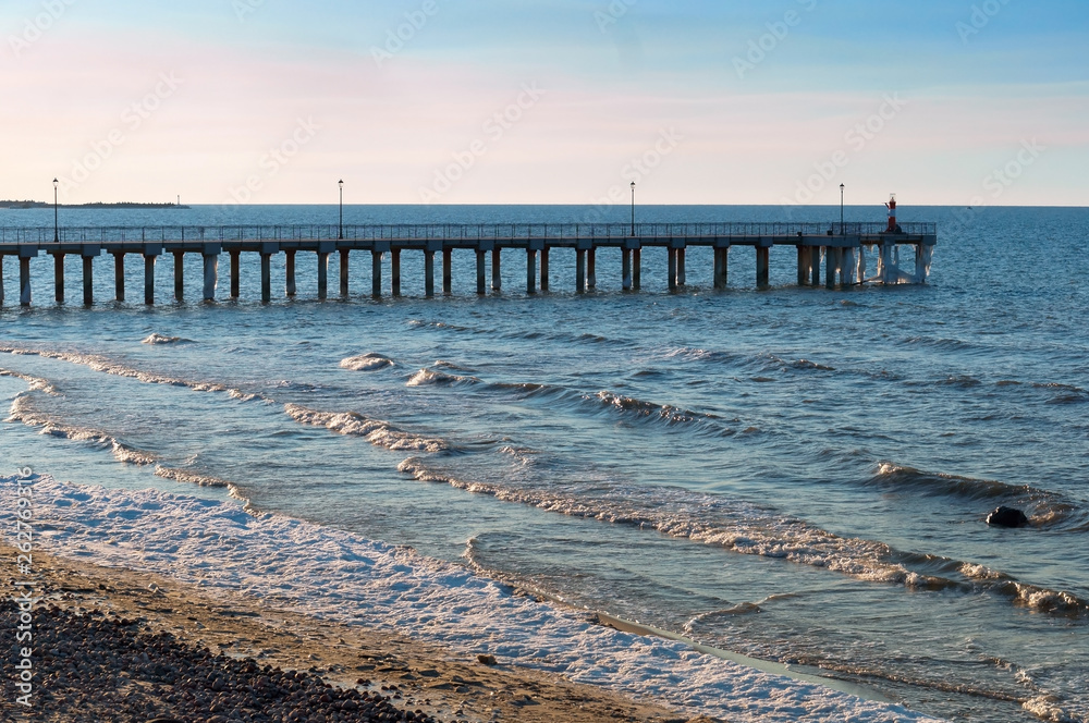 Dawn hour on the sea. Pier in the sea. Evening seascape.