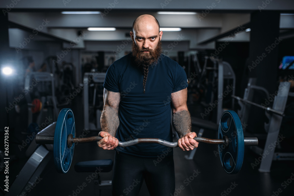 Muscular athlete in sportswear takes weight Muscular athlete in sportswear takes weight