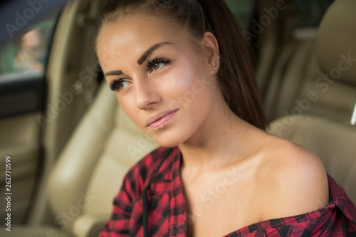 Young woman in red shirt in the car