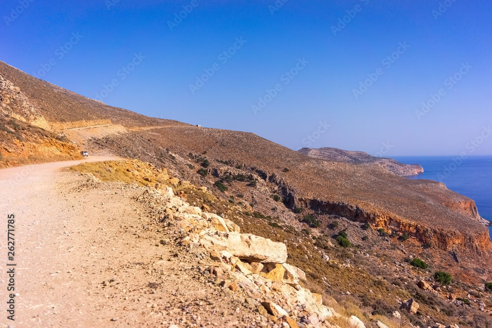 Car on the mountain road on the way to the beach of Balos in Crete Car on the mountain road on the way to the beach of Balos in Crete