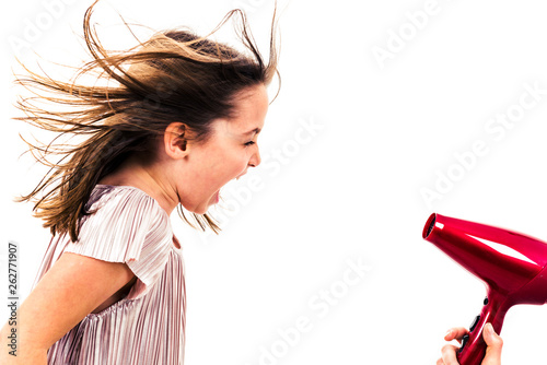 Girl is yelling, shouting at blow dryer - hair dryer.