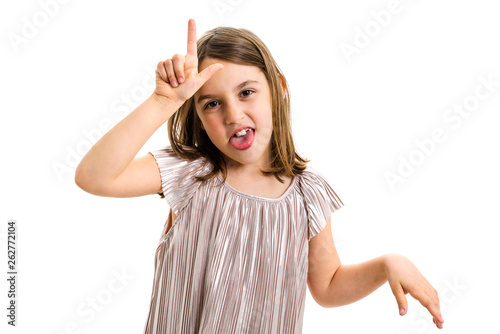 Portrait of happy girl making loser hand gesture at camera.