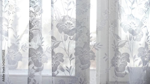 white curtain sways in the wind