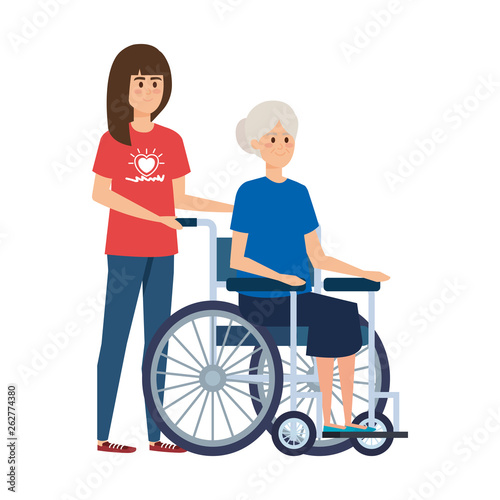 young woman volunteer with old woman in wheelchair