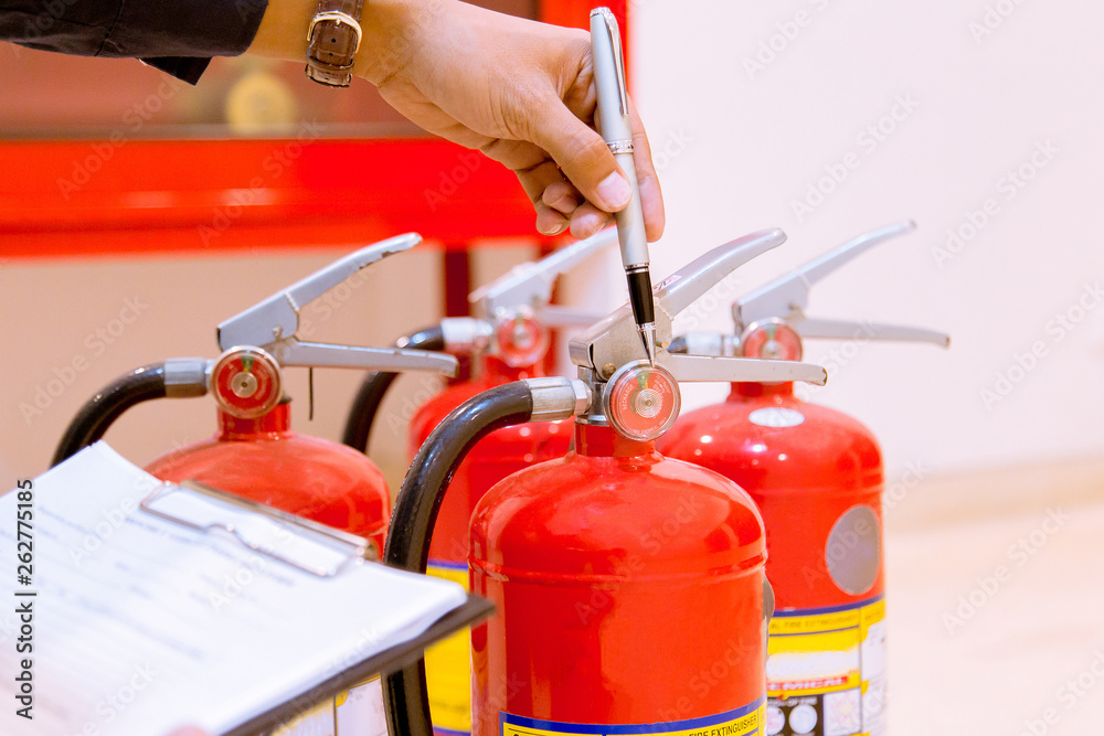 Male Professional inspection Fire extinguisher,safety concept.